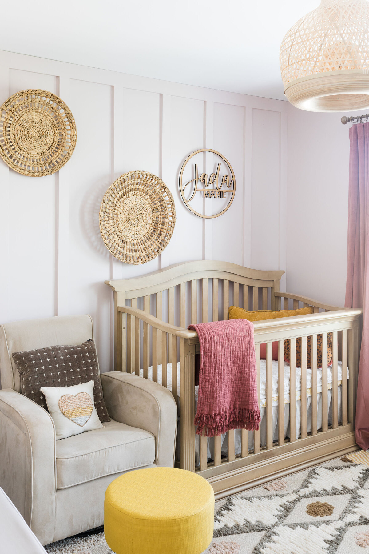 a crib, rocking chair, and artwork in a nursery