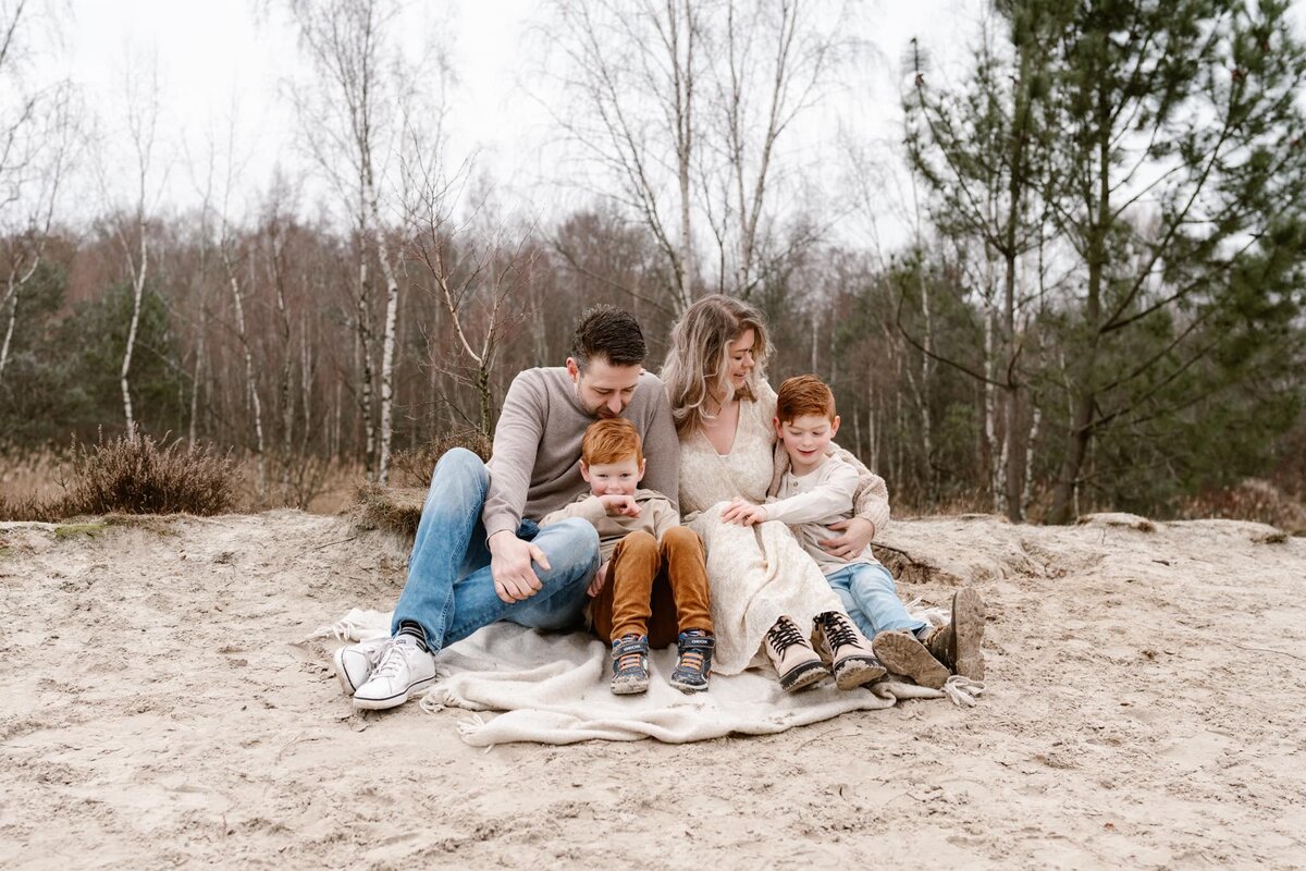 gezinsfotograaf Drenthe - gezin knuffelen in natuur fotoshoot.