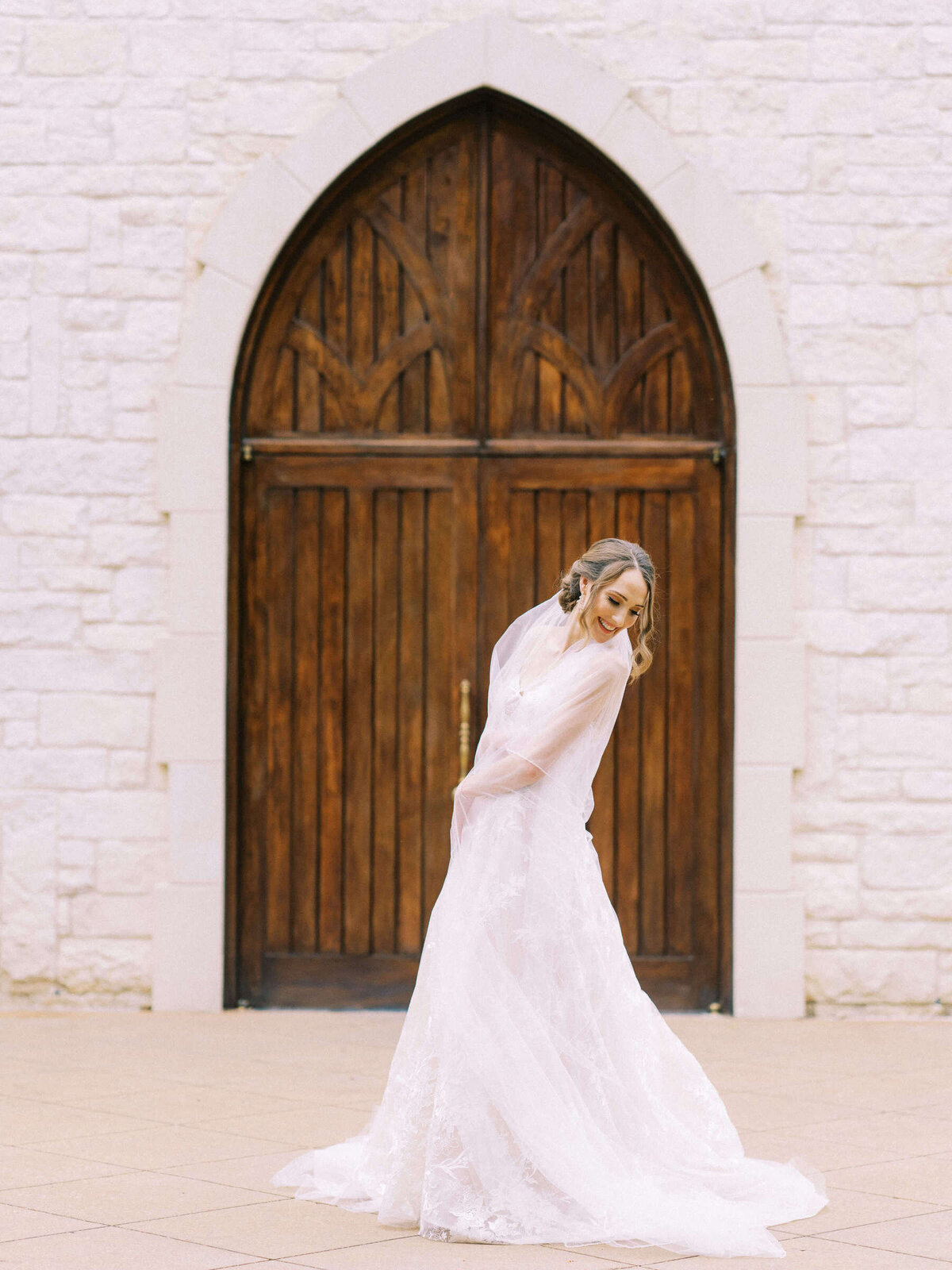 Joyful bride at Ashton Gardens twirls in her Monique Lhuillier wedding dress