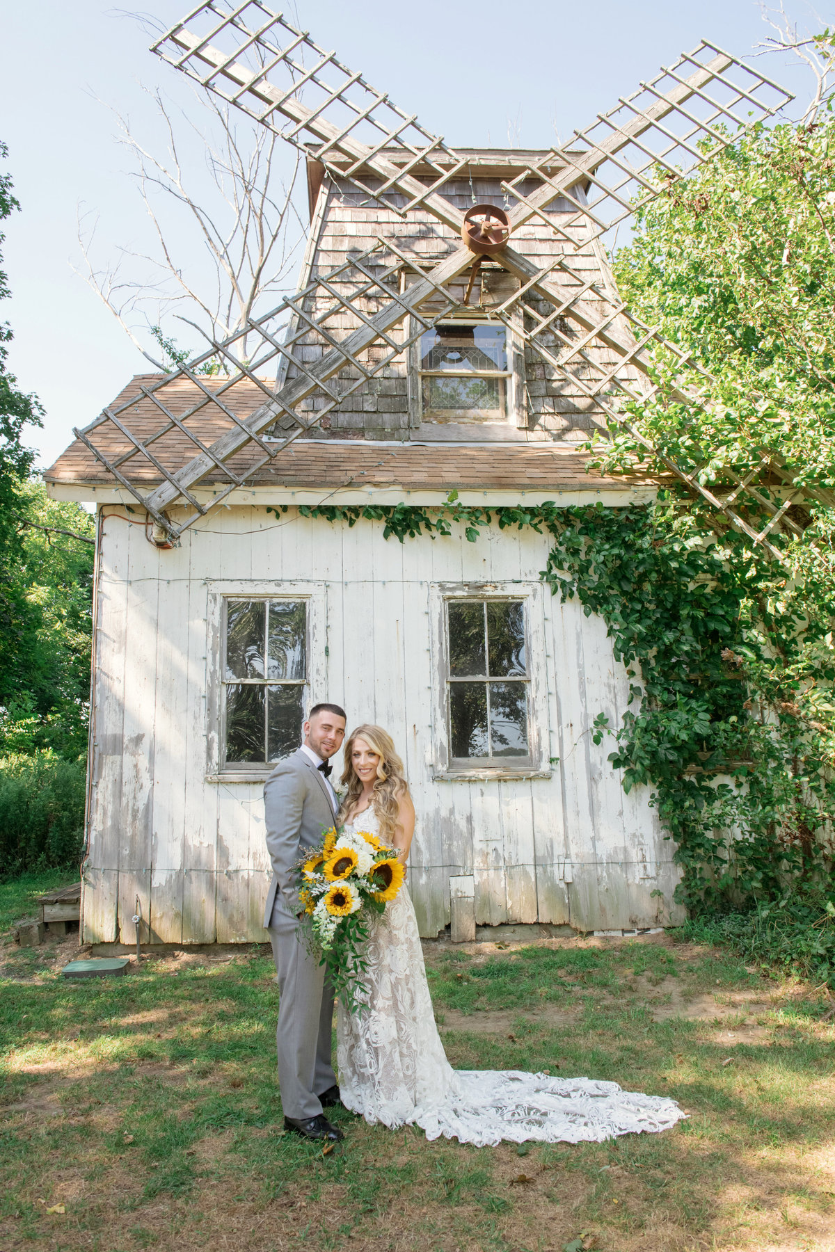 bride and groom in front of windmill at Giorgios Baiting Hollow