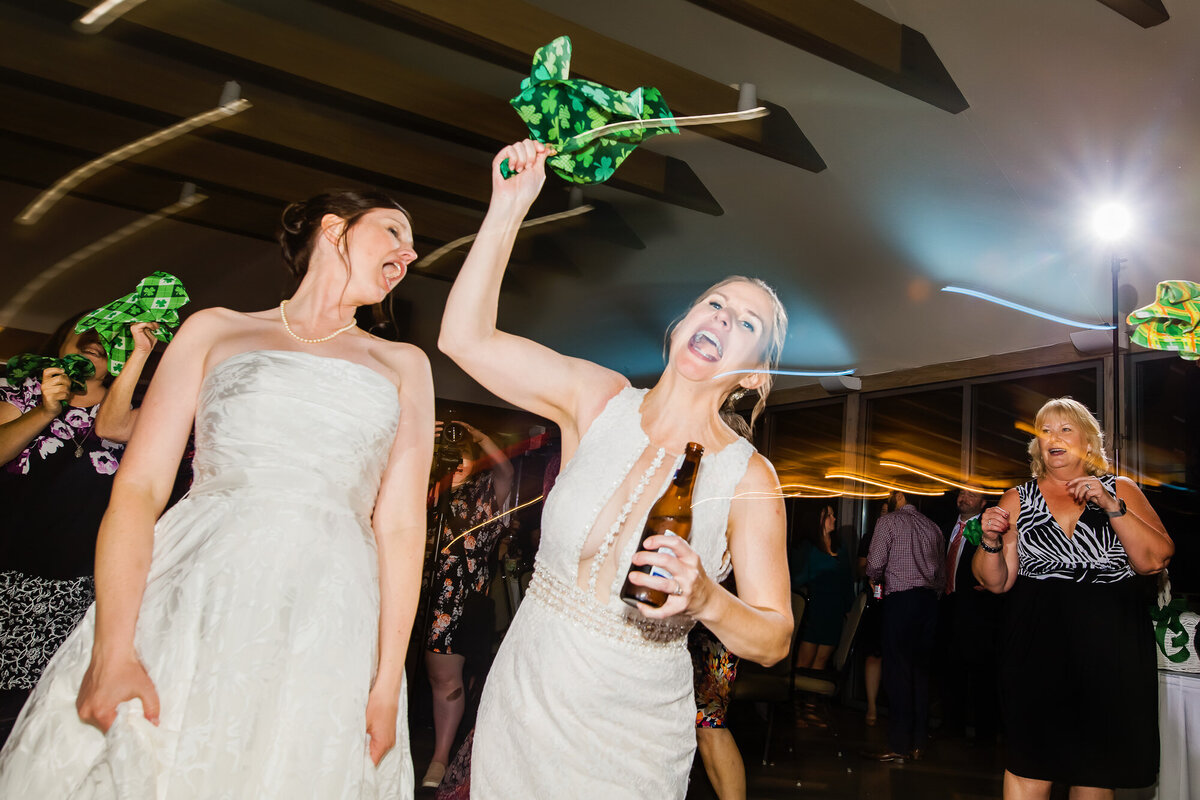 Brides dancing at celebrating at their wedding reception