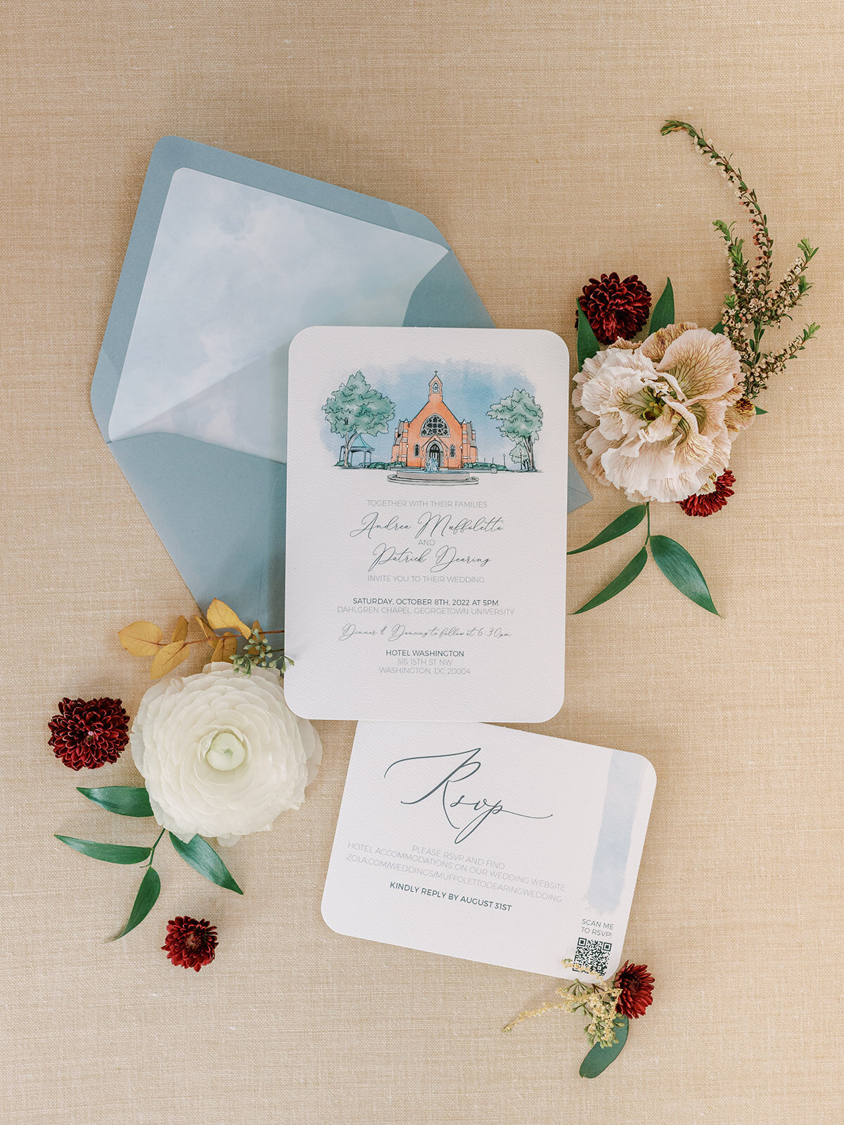 Blue and tan fall wedding flowers surround invitation suite for wedding in Georgetown DC