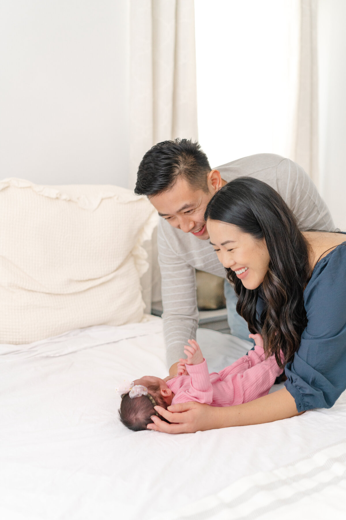 newborn baby inspiration pose with parents at home