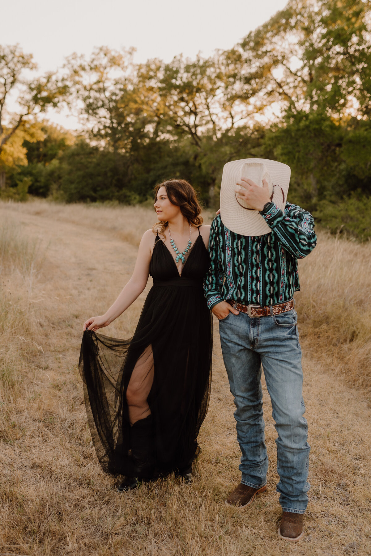 western couple posing in field