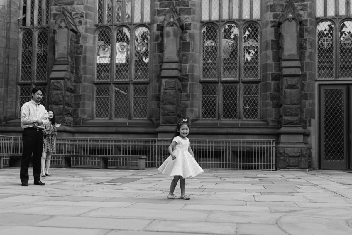 little girl dancing near old building