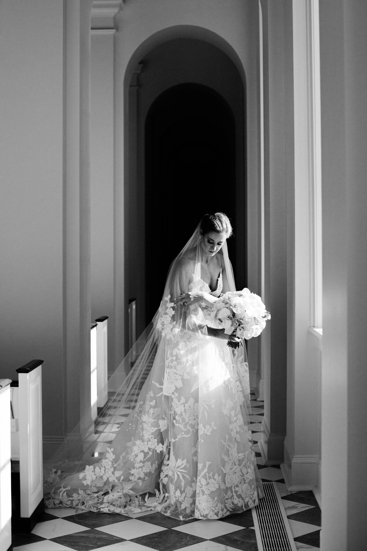 Black and white portrait of a bride in a luxury wedding gown in a church in Memphis Tennessee