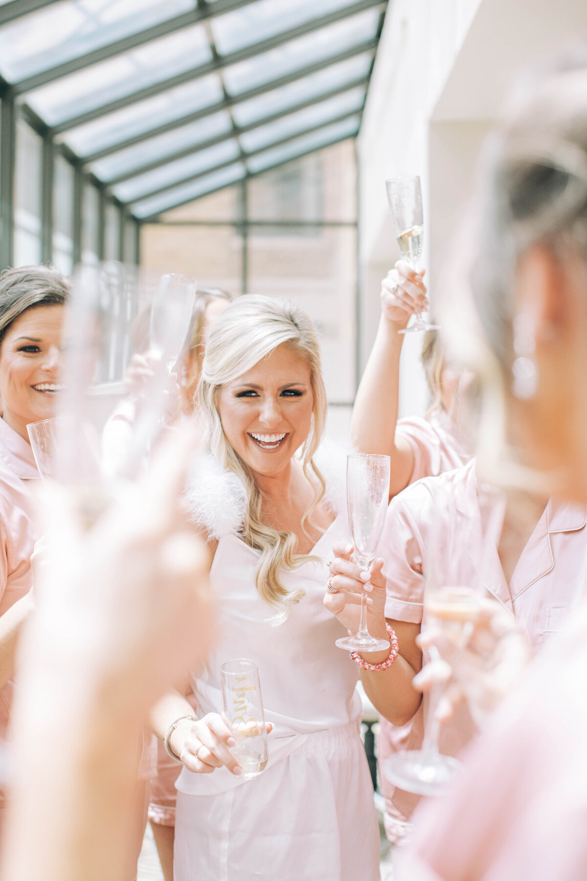 Bridal party laughing and toasting to the bride at a wedding in Nashville, Tennessee
