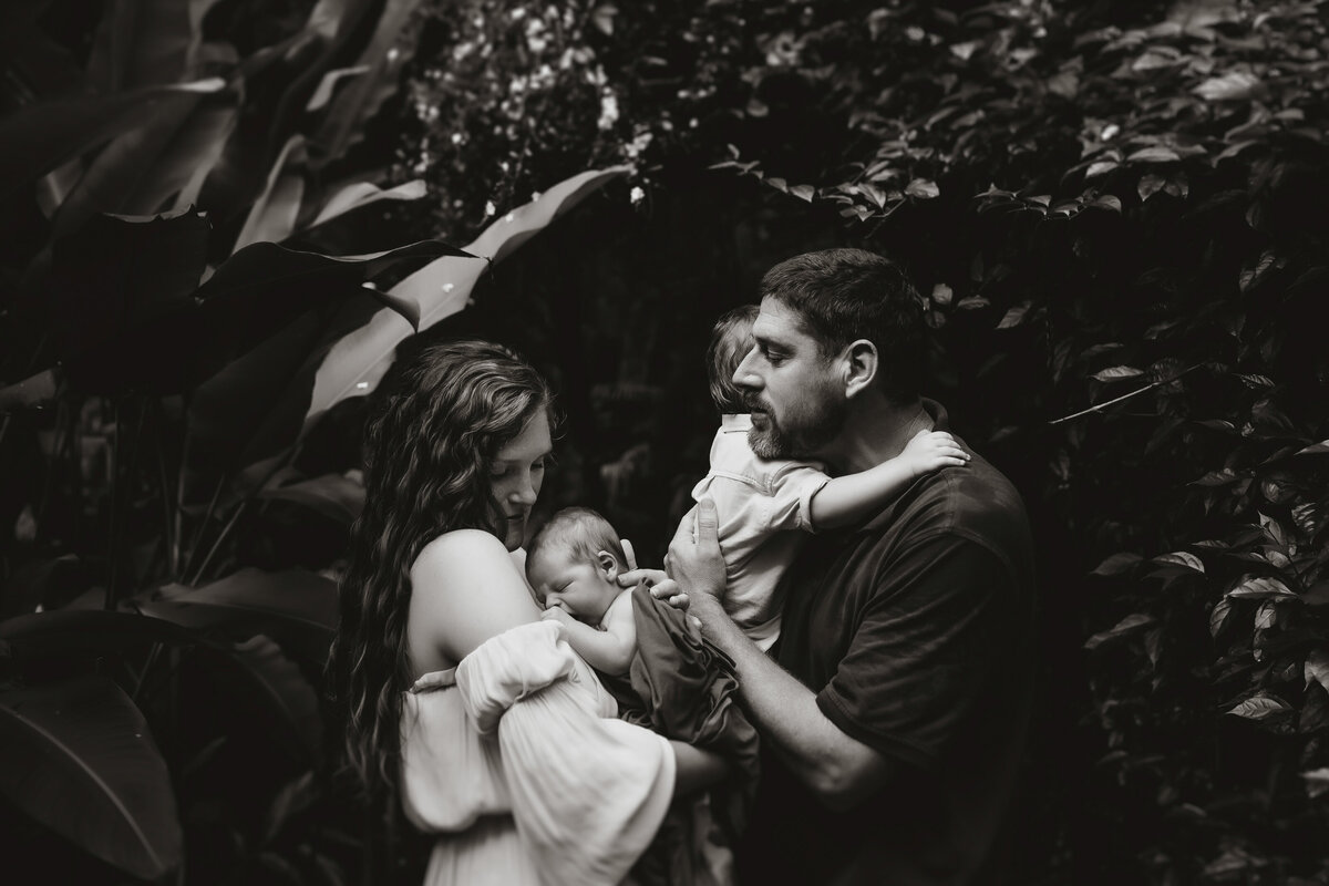 a black and white family newborn photo session outside