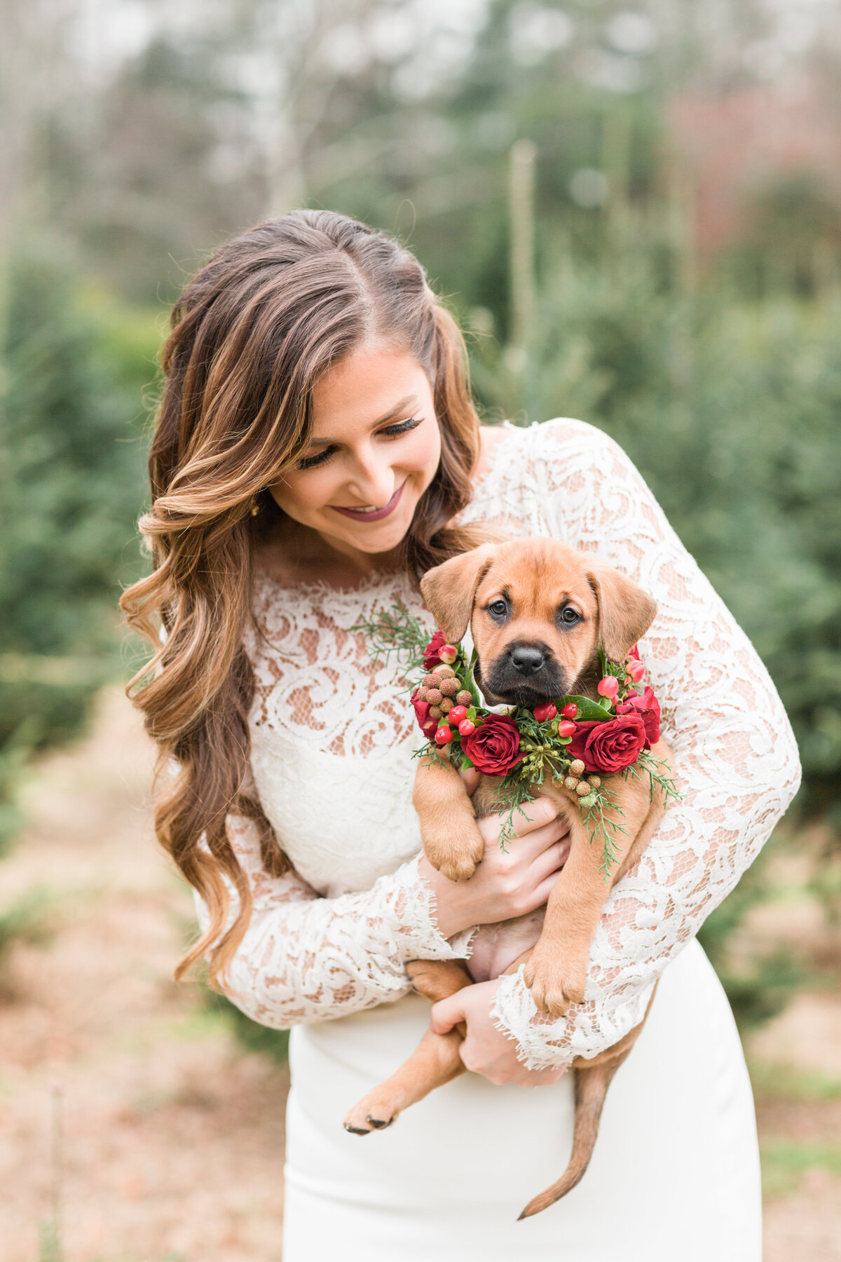 Bride holding an adoptable puppy in a flower collar