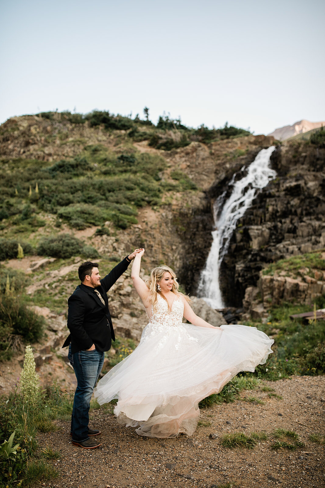 Ouray elopement couple dancing in front of waterfall