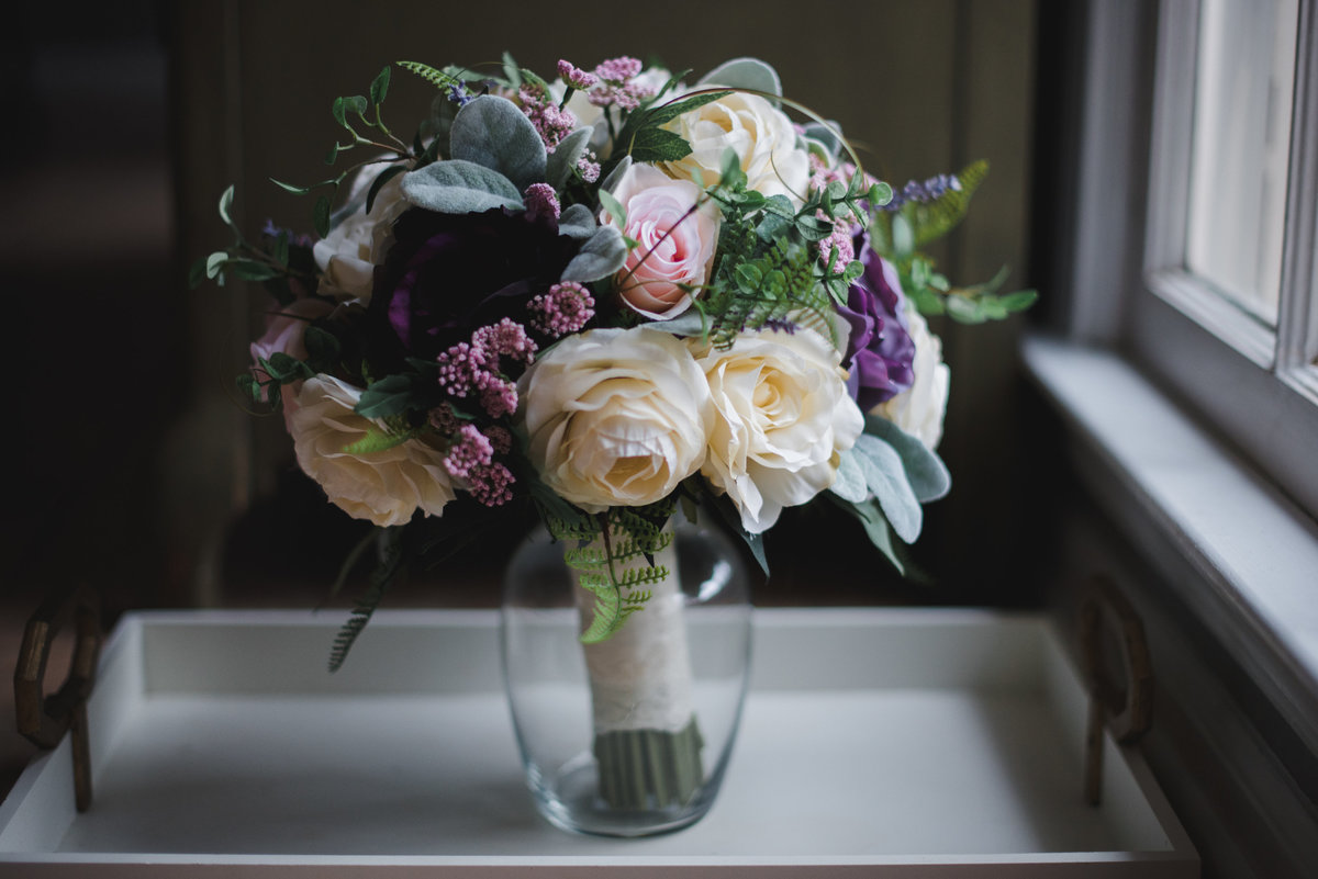 wedding bouquet by a window sill  in a vase