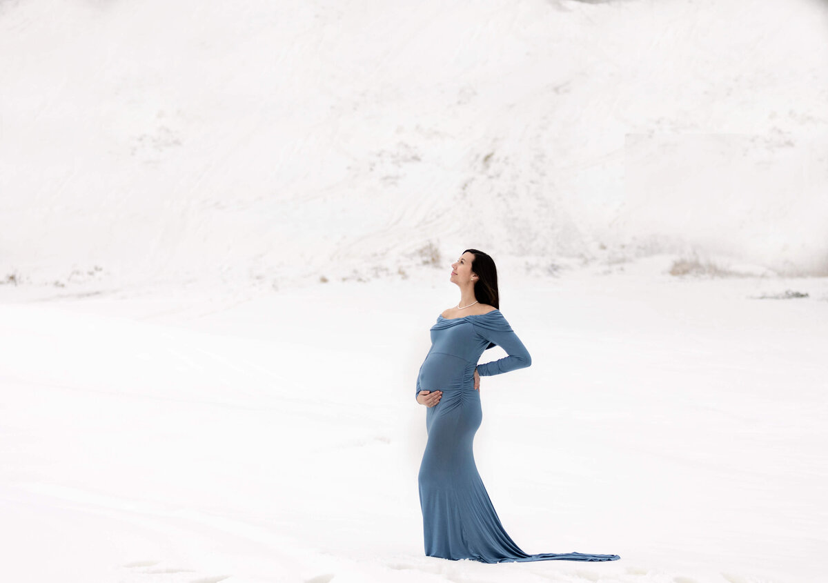 Maternity photo of a woman in the snow at Peak n Peek ski resort in Clymer NY by an Erie Pa photographer