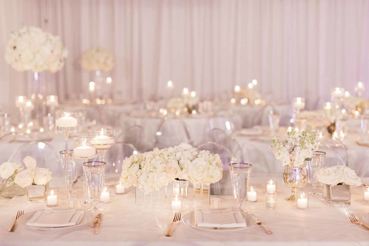 We designed all white clean flowers for this Canvas Event Space wedding filled with candlelit