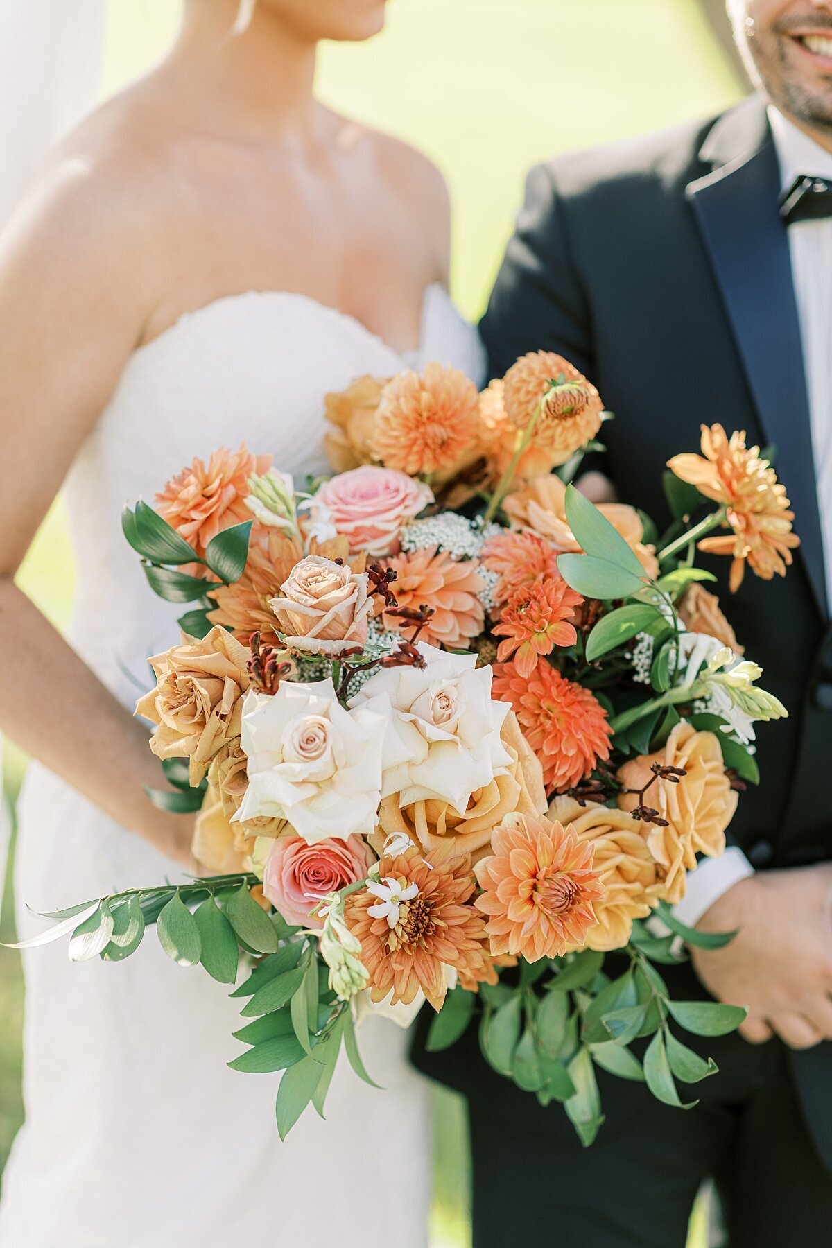 orange and pink bridal bouquet at the Barn at Silverstone
