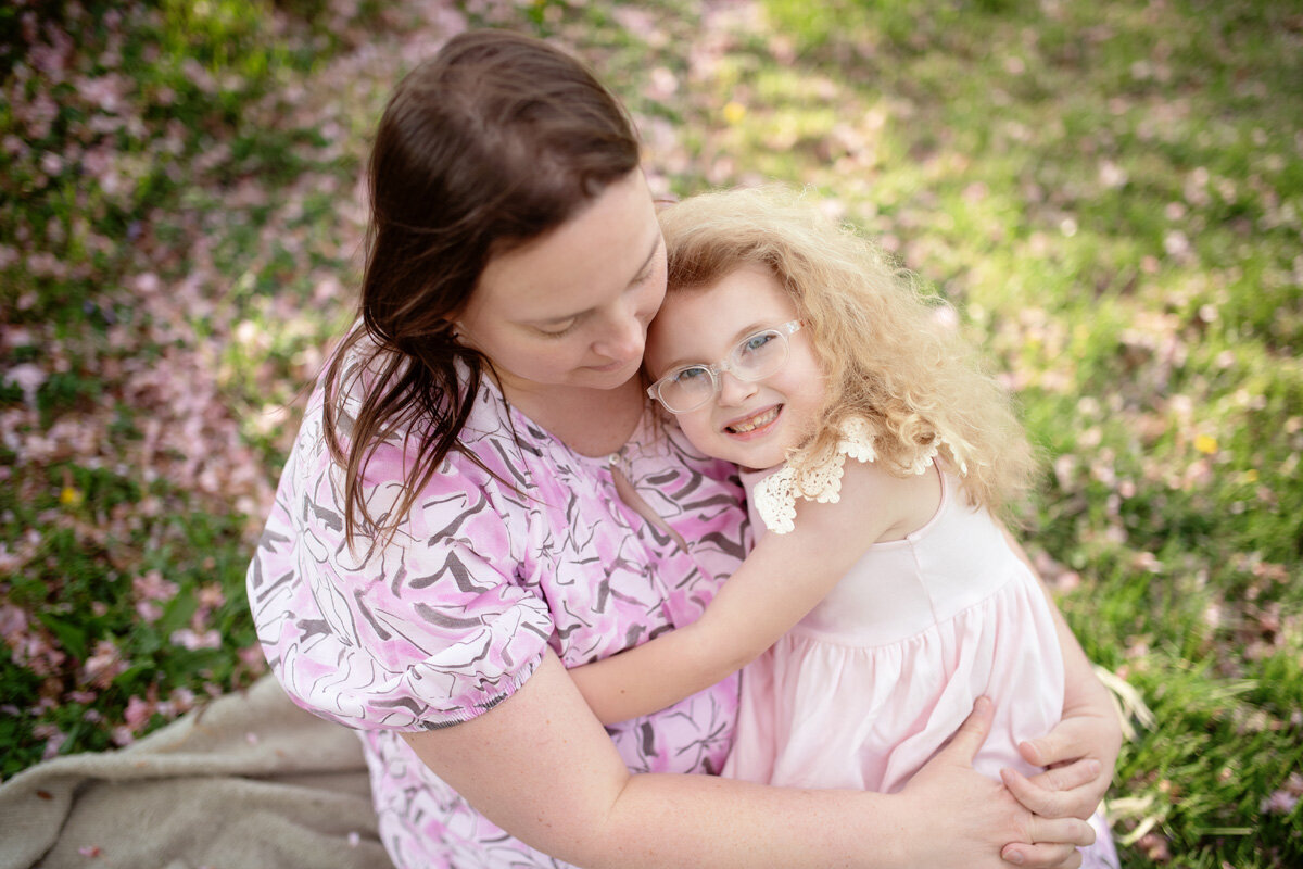 Family session of little girl and her mother in a dress