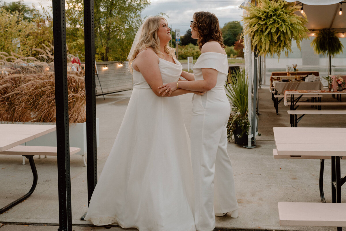 brides celebrate finally being married on the patio