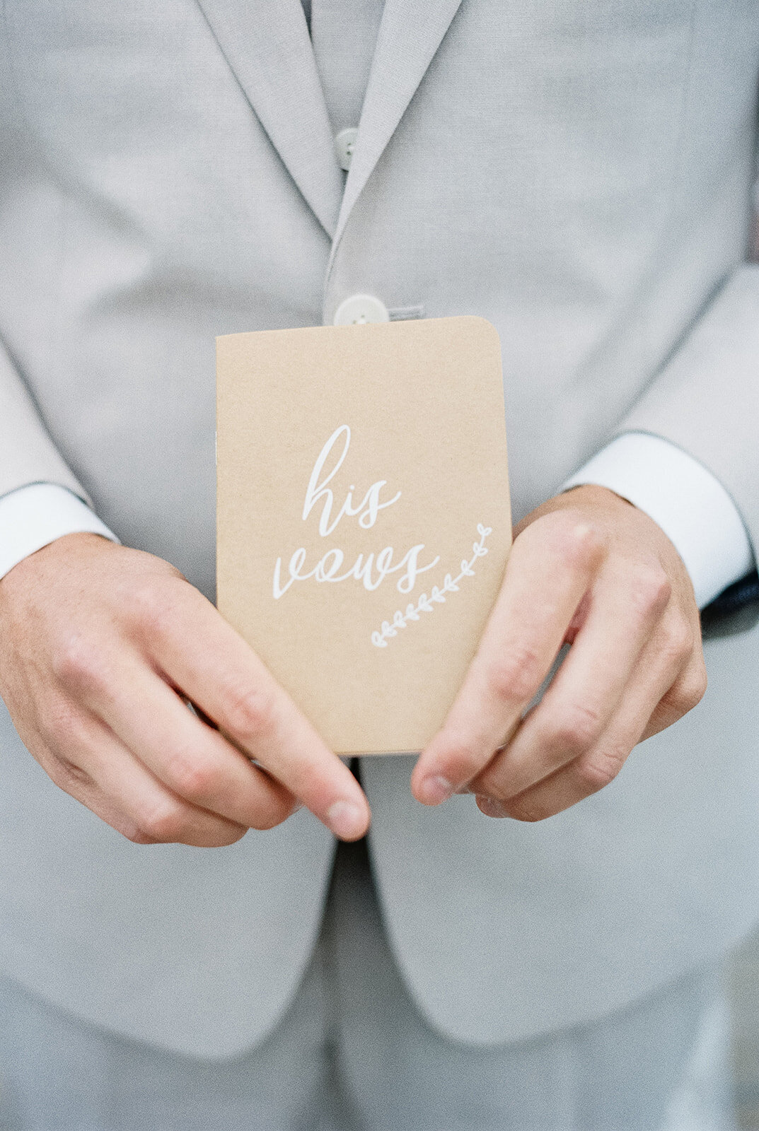 Groom holding vow book, xLight and airy wedding photography by the Best Boise Wedding Photographers
