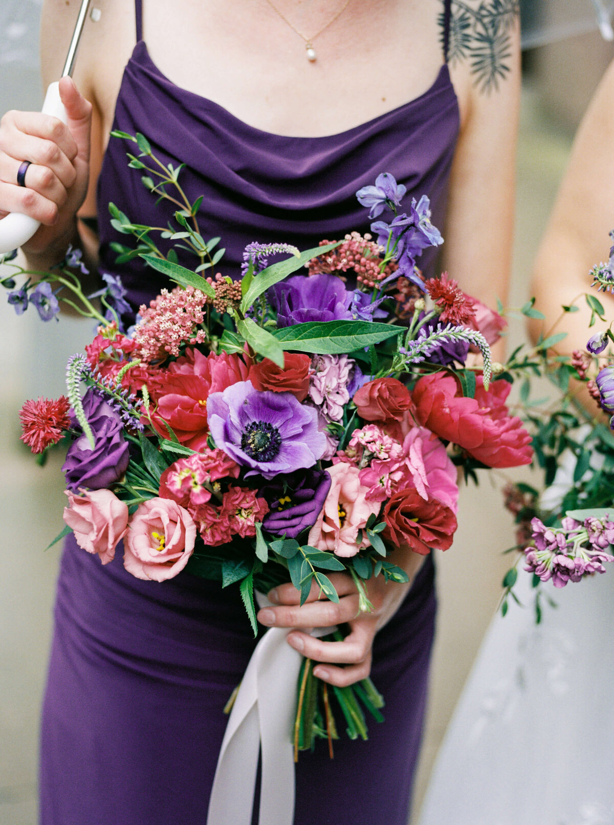 Bride holding colorful bouquet of florals at Halifax Club in Nova Scotia
