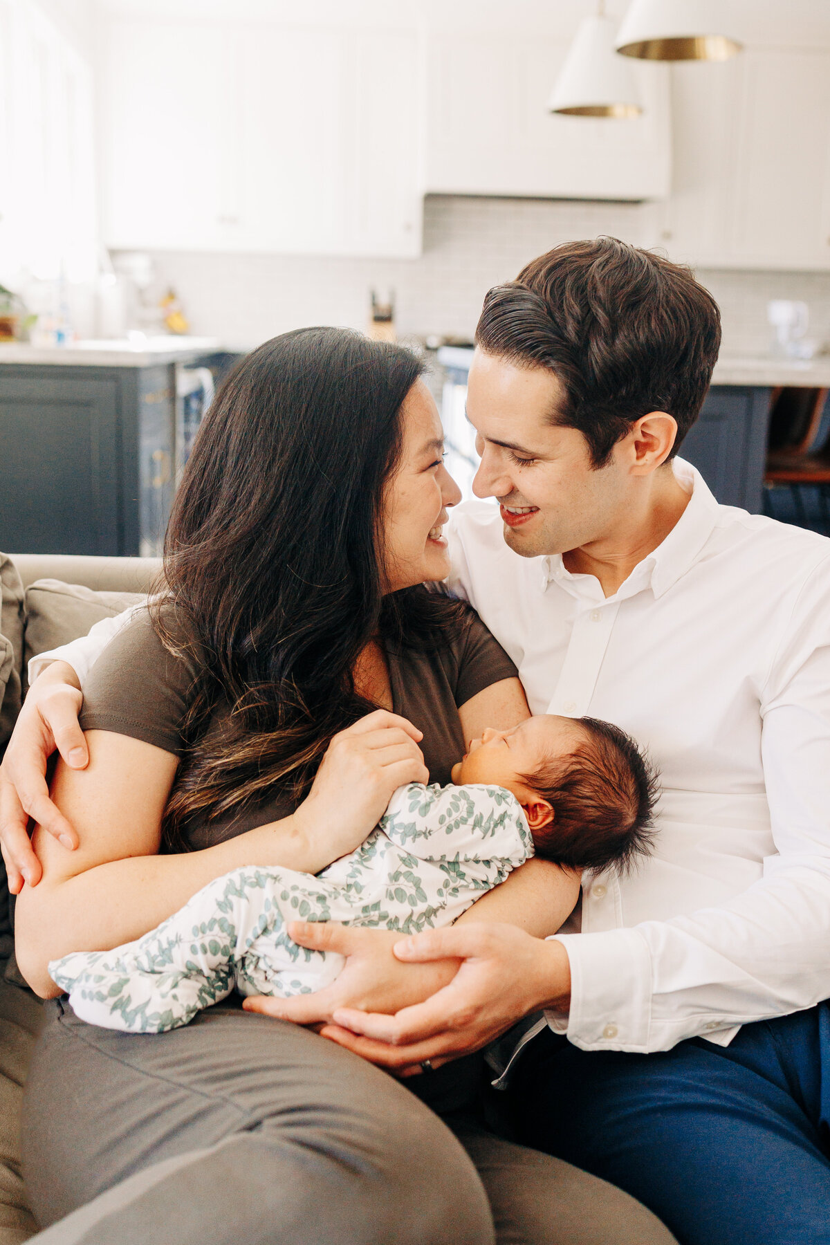 parents with their newborn baby during a photography session