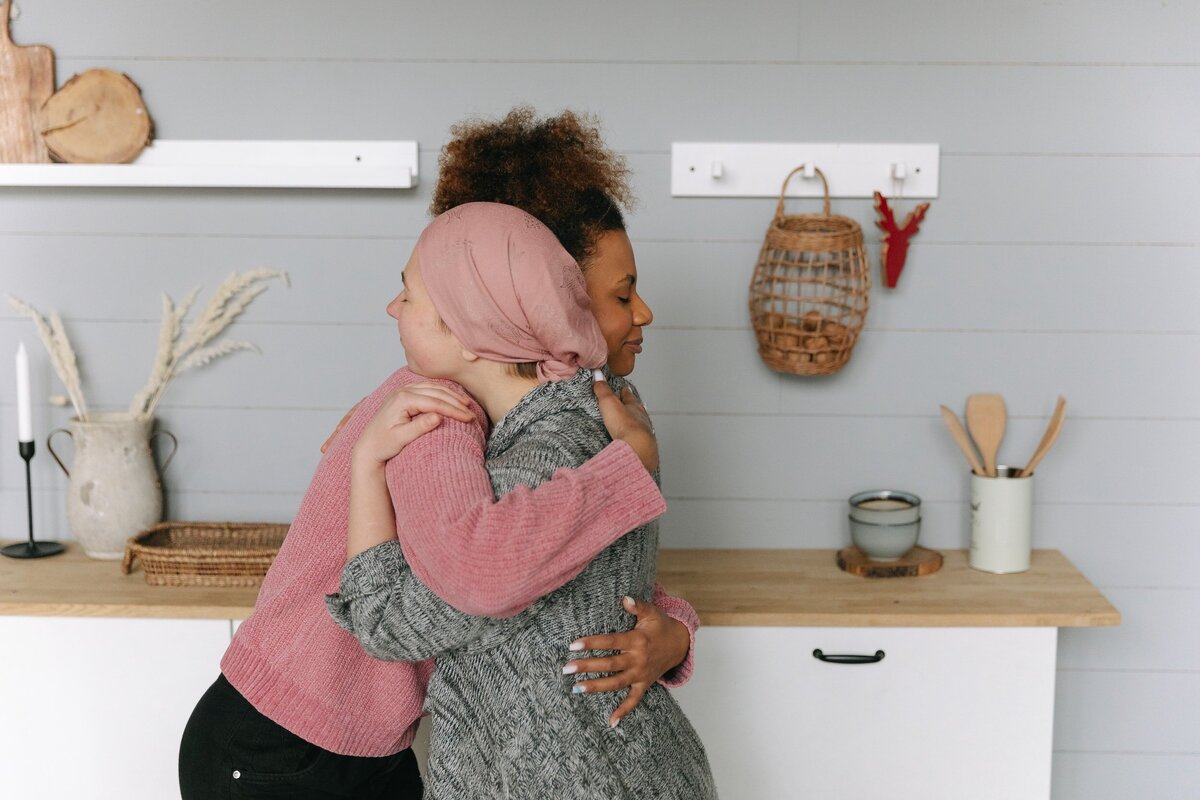 Two women hugging in the kitchen