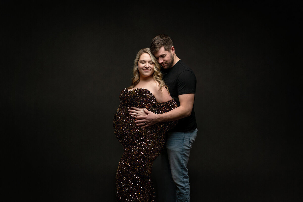 Expecting parents pose for their maternity session in Minnesota.