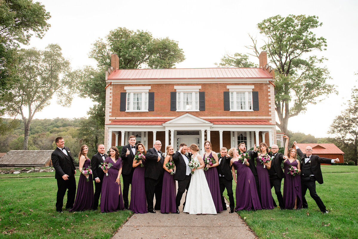 Funny group photo of the full wedding party all together outside of Ravenswood Mansion