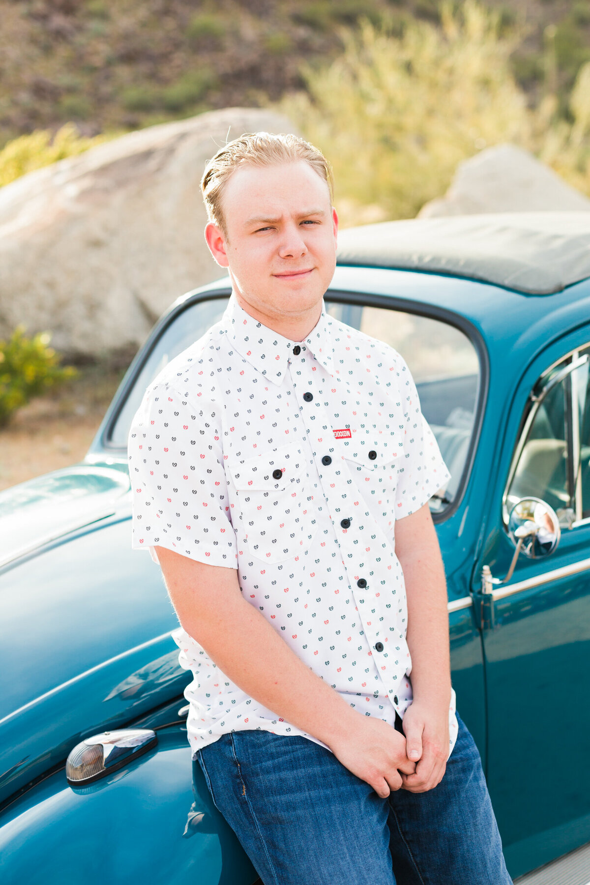 high school senior boy posing for Scottsdale senior photography session with VW bug