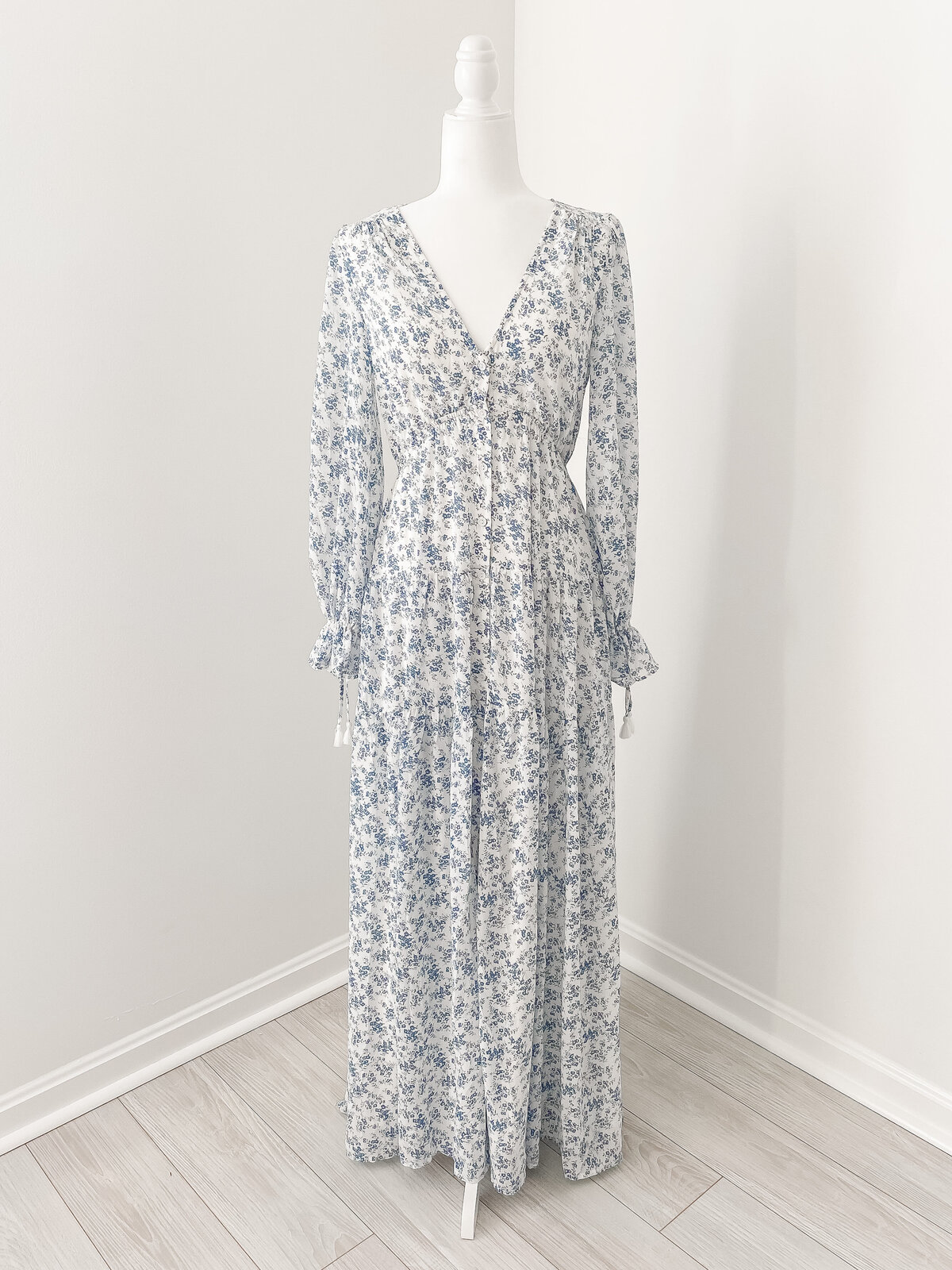 A DC Family Photographer white maxi dress  with blue flowers and long sleeves and a v neck