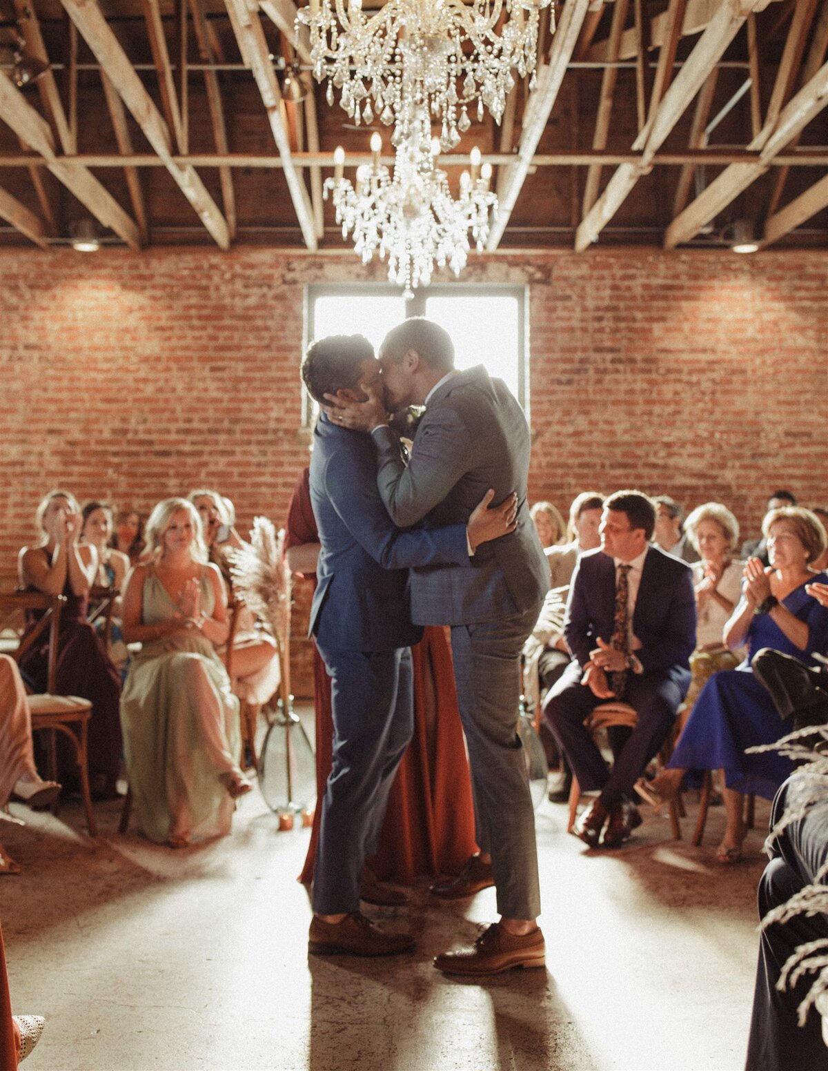 Grooms kissing after wedding ceremony at The St Vrain, Longmont wedding venue