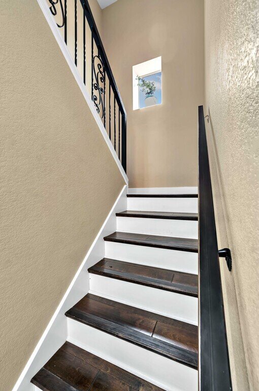 Staircase with railing in this four-bedroom, four-bathroom vacation rental home and guest house with free WiFi, fully equipped kitchen, firepit and room for 10 in Waco, TX.