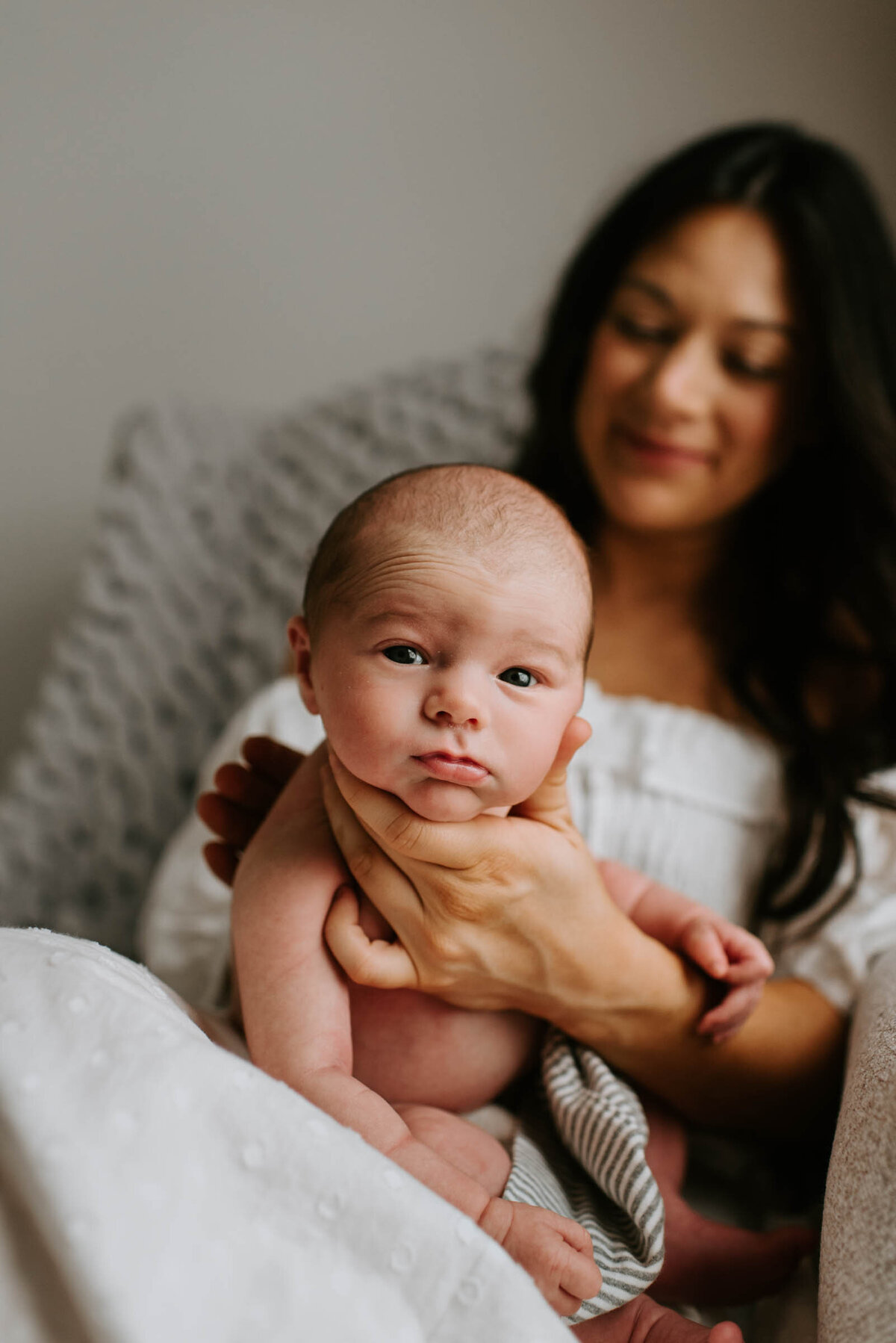 Mother burping newborn baby in nursery Newborn Portrait Photography
