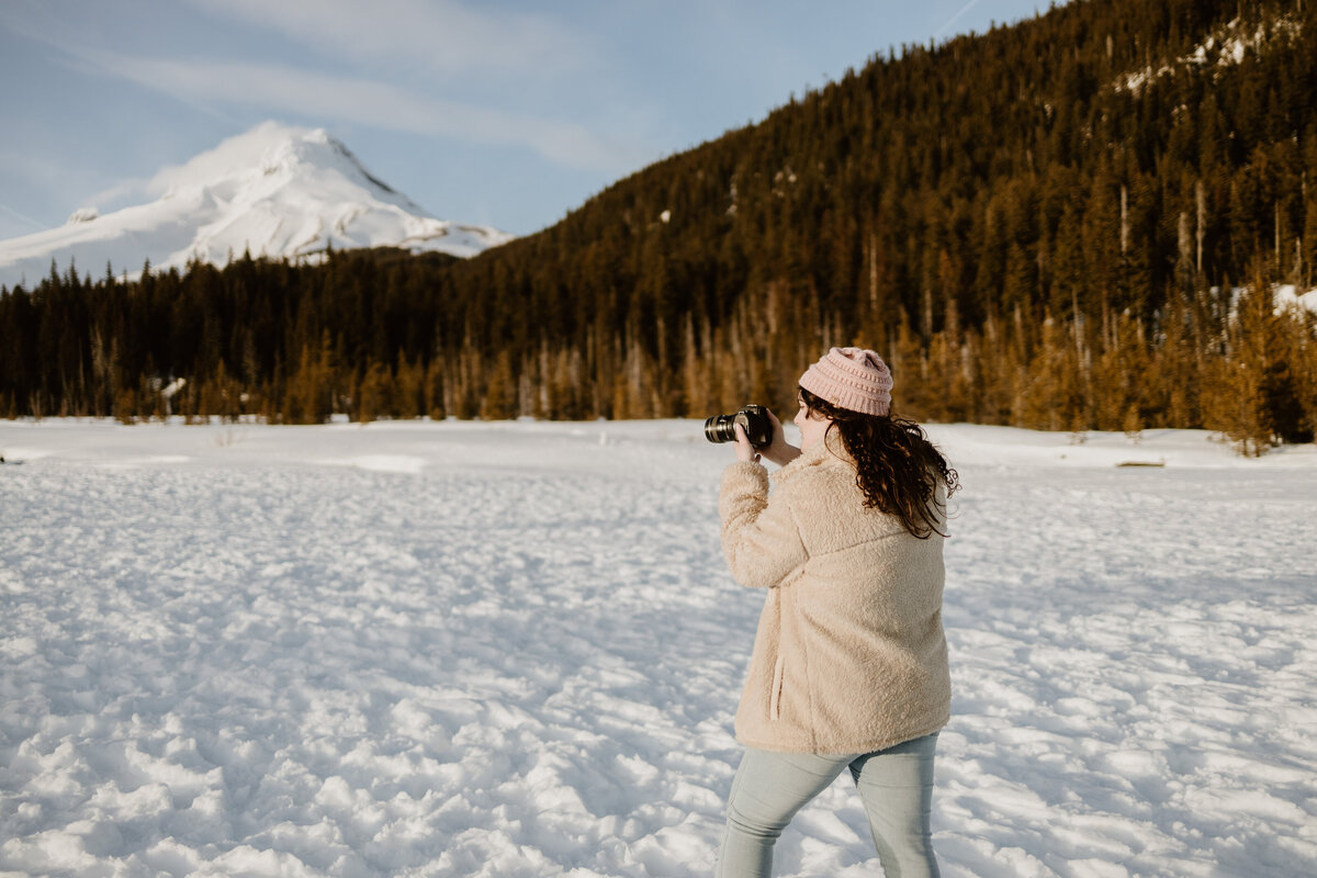 Mt Hood Elopement Photographer Takes a photo while walking in a snowy pasture