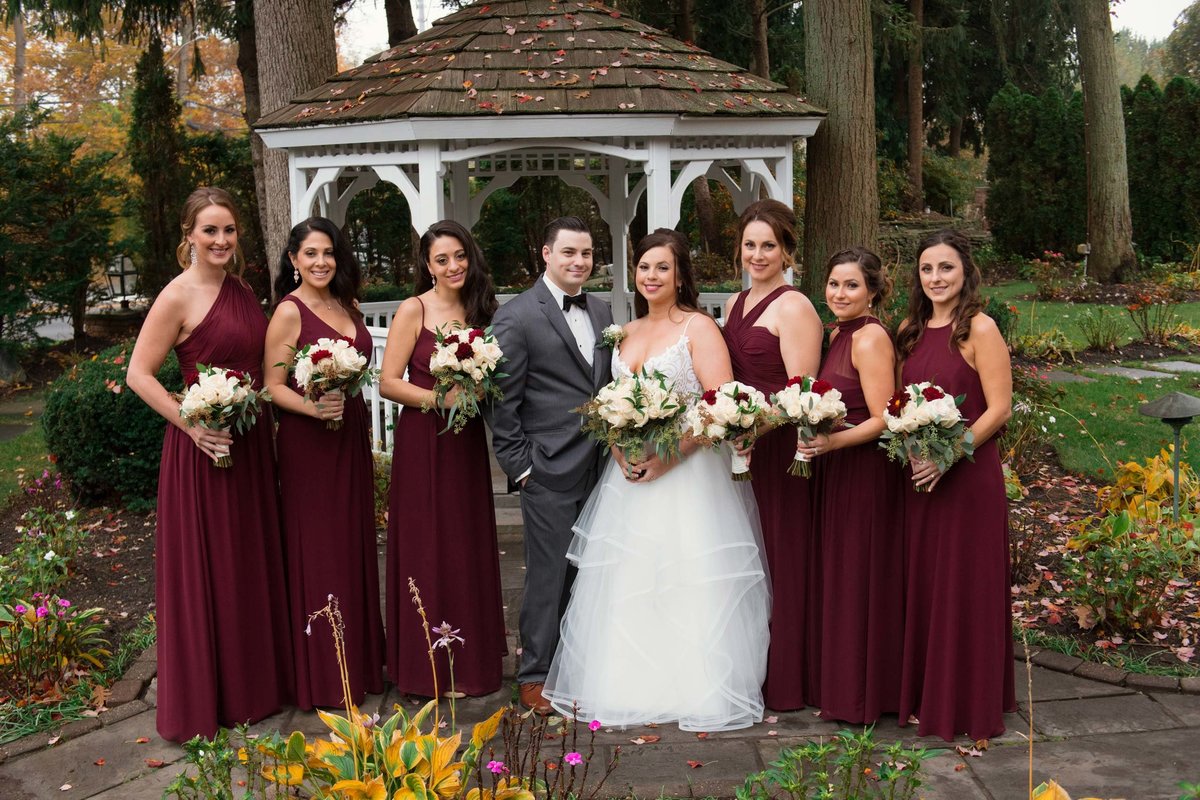 Bridesmaids in red dresses at Fox Hollow