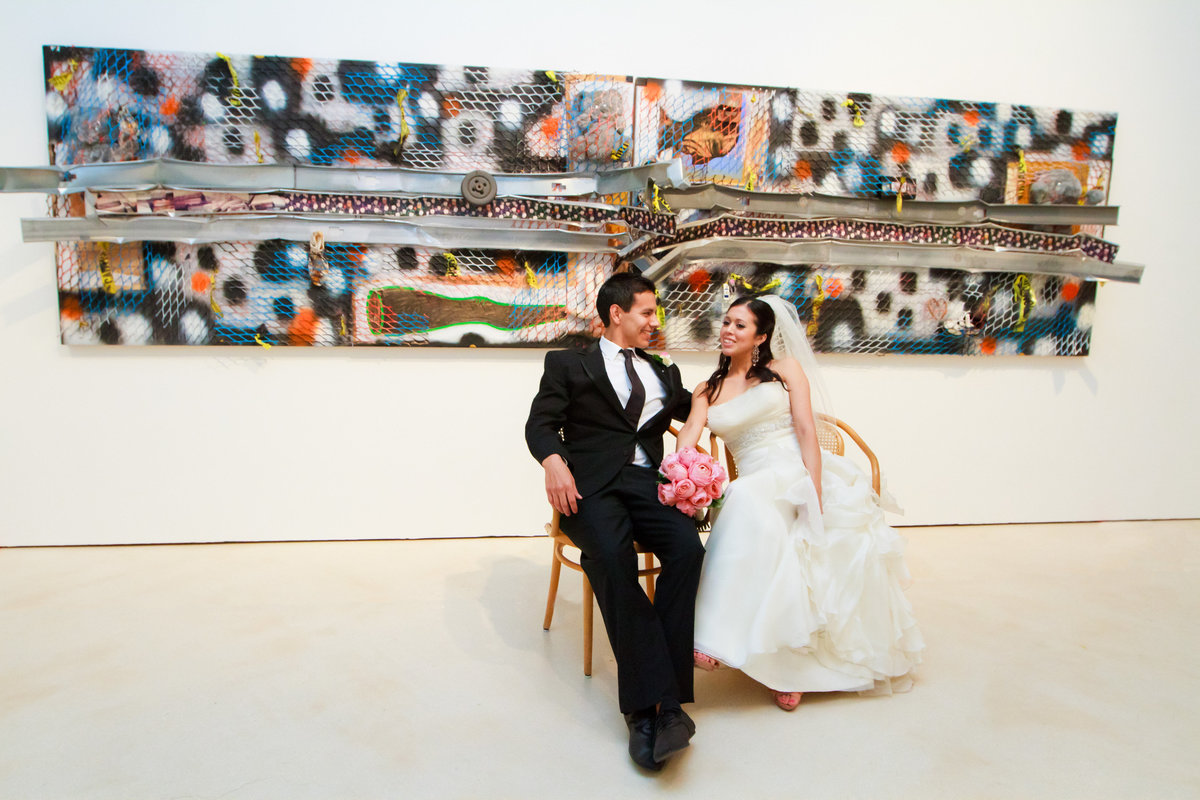 bride and groom at San Antonio Museum of Art after their wedding posing inside the museum