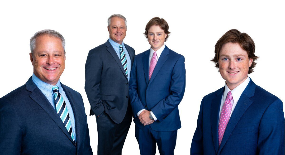 An older man and a younger man in business suits pose for their business headshots individually and together.