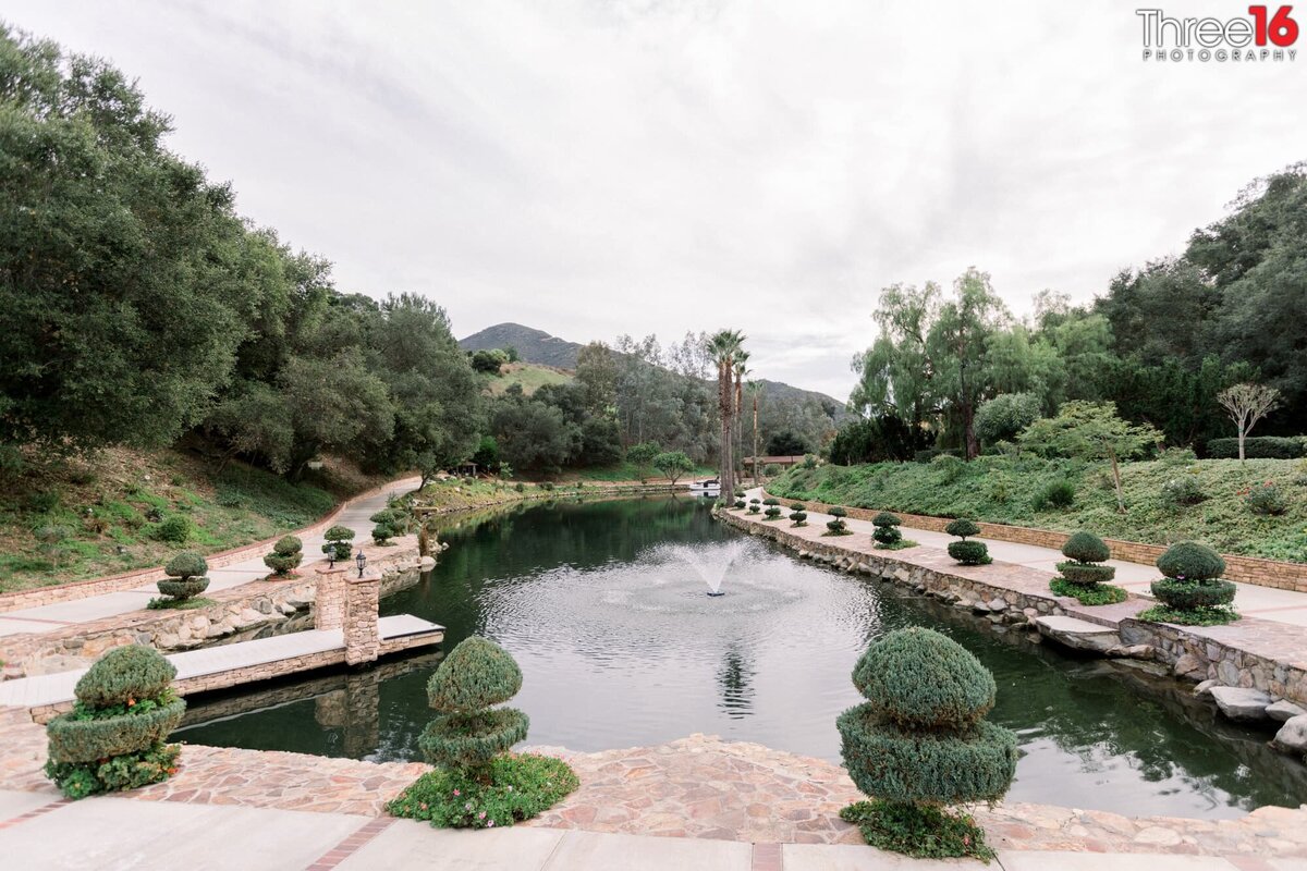 Beautiful pond with flowing water fountain in the middle at the Los Willows Wedding Estate