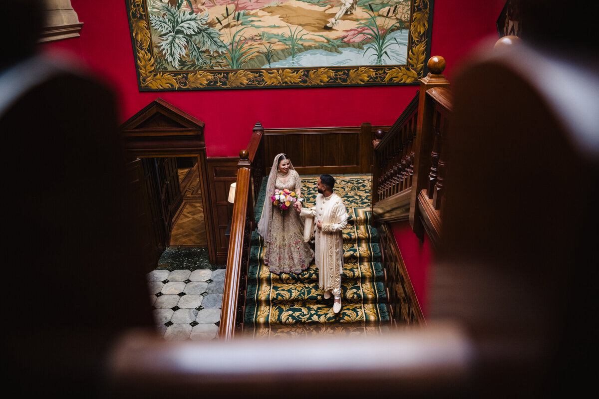 Couple walking down the stairs at Staplefor dpark hotel wedding