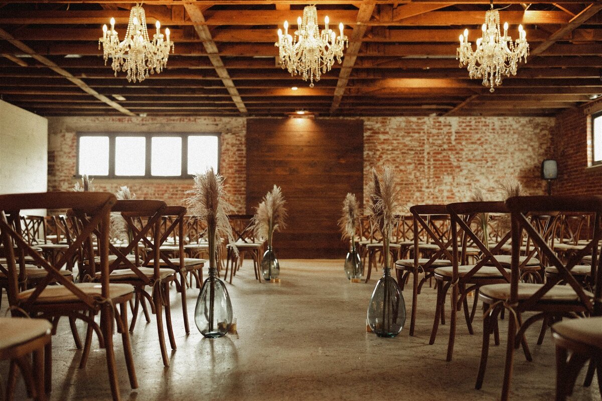 wedding ceremony with pampas grass and chandeliers at Longmont wedding venue, The St Vrain