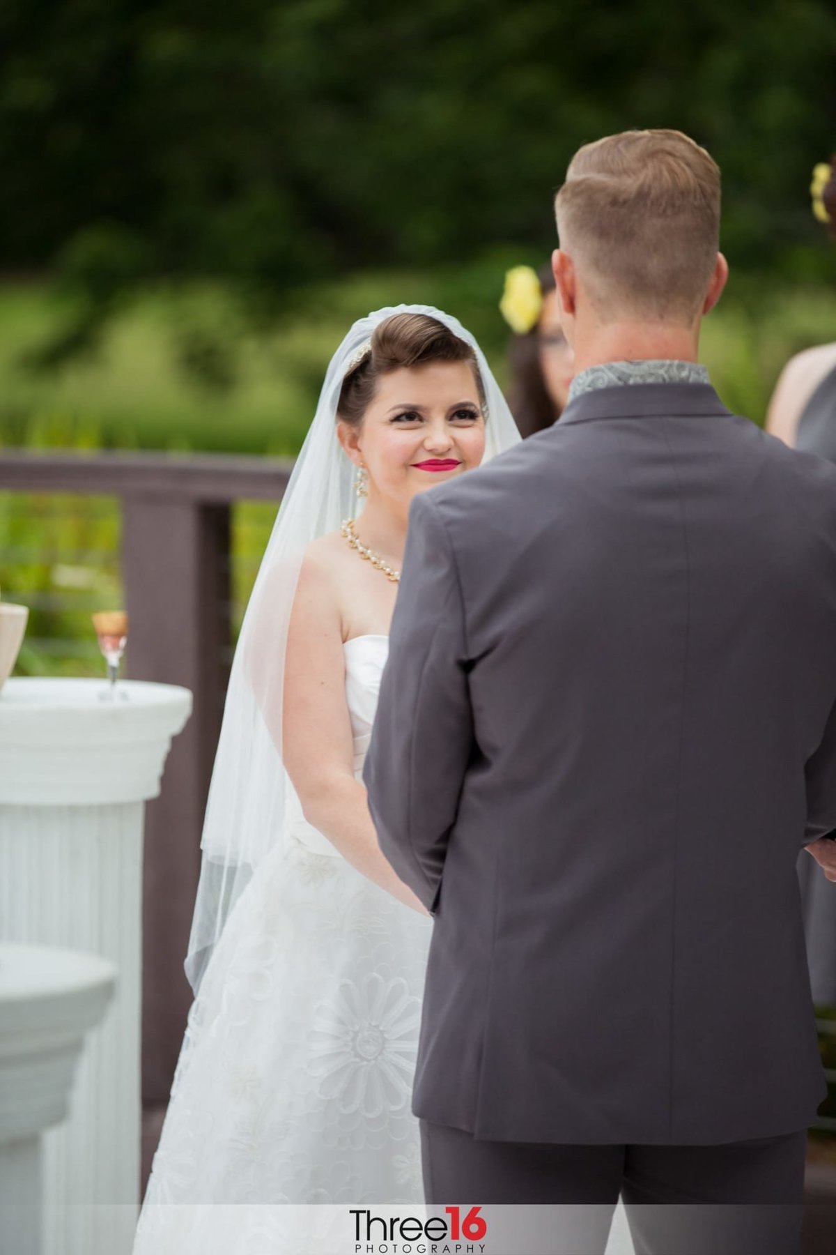Bride looks at her Groom during the wedding ceremony and smiles