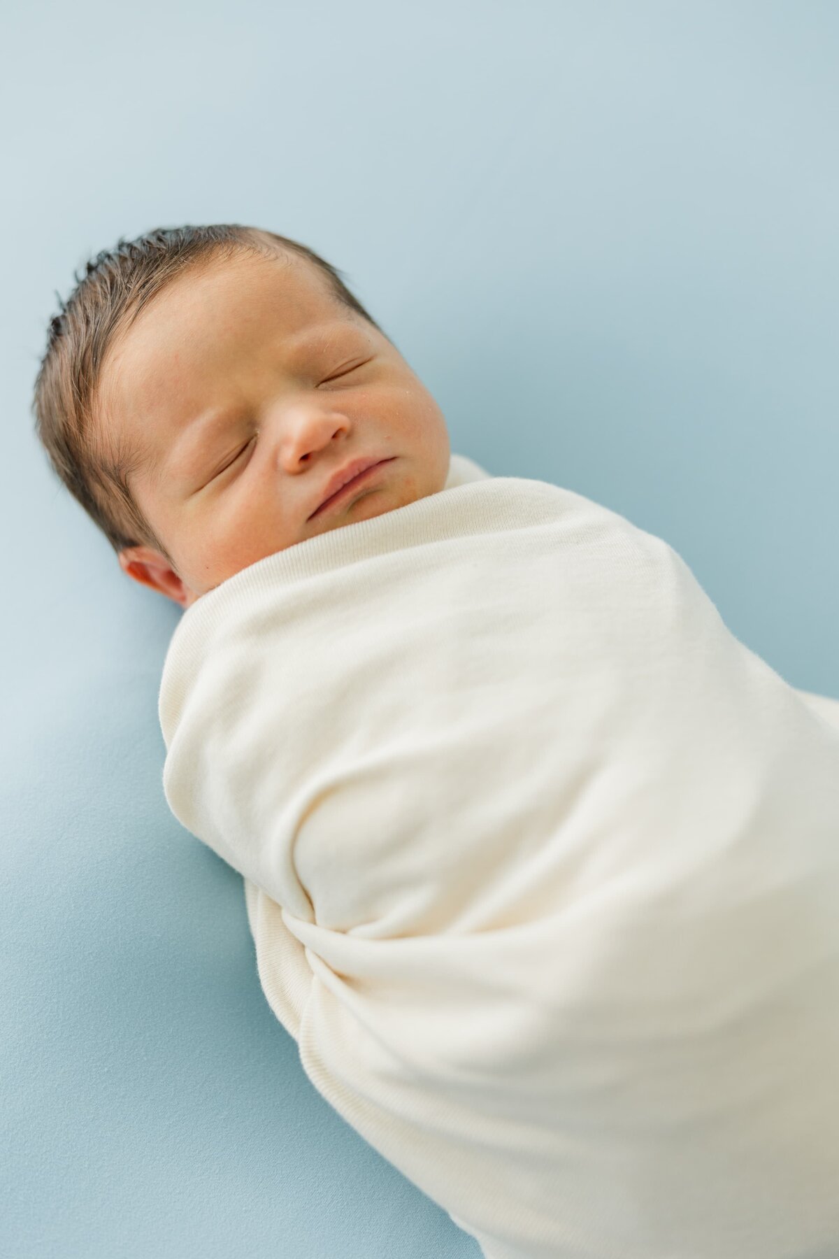 newborn baby swaddled during photo shoot