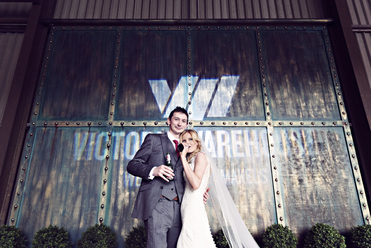 A bride and groom enjoying a beer at Victoria Warehouse Manchester City
