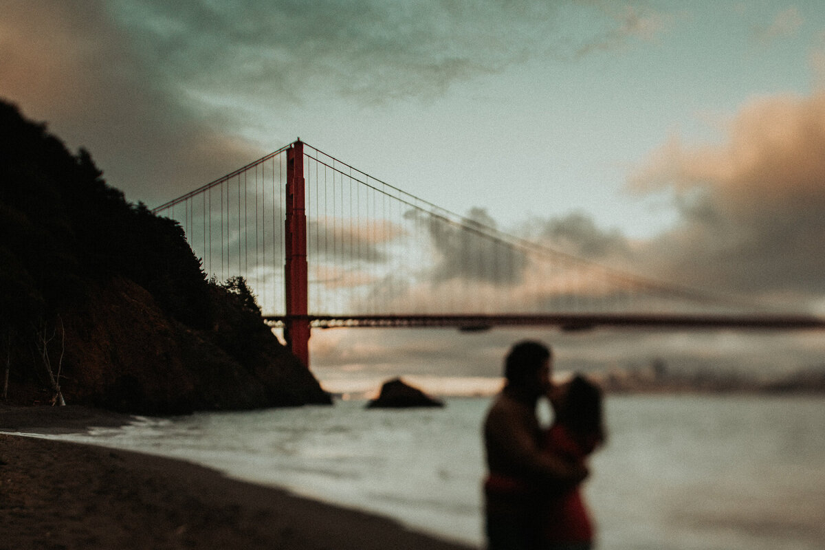 Bay Area elopement photography session with couple kissing in front of Golden Gate bridge