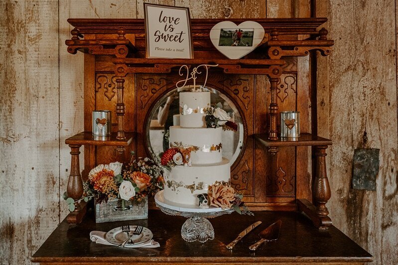 Wedding cake with flowers inside a rustic farm barn