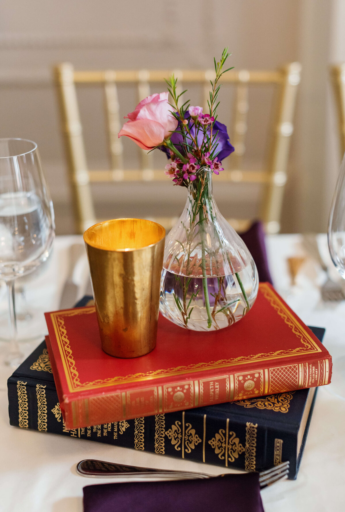 Vase and candle set upon two books at  at Halifax Club wedding in Nova Scotia