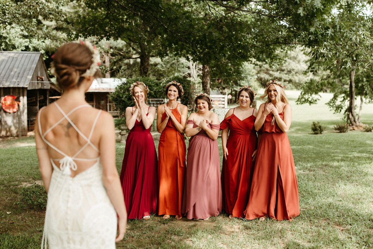 Boho bridesmaids hyping up the bride during their first look
