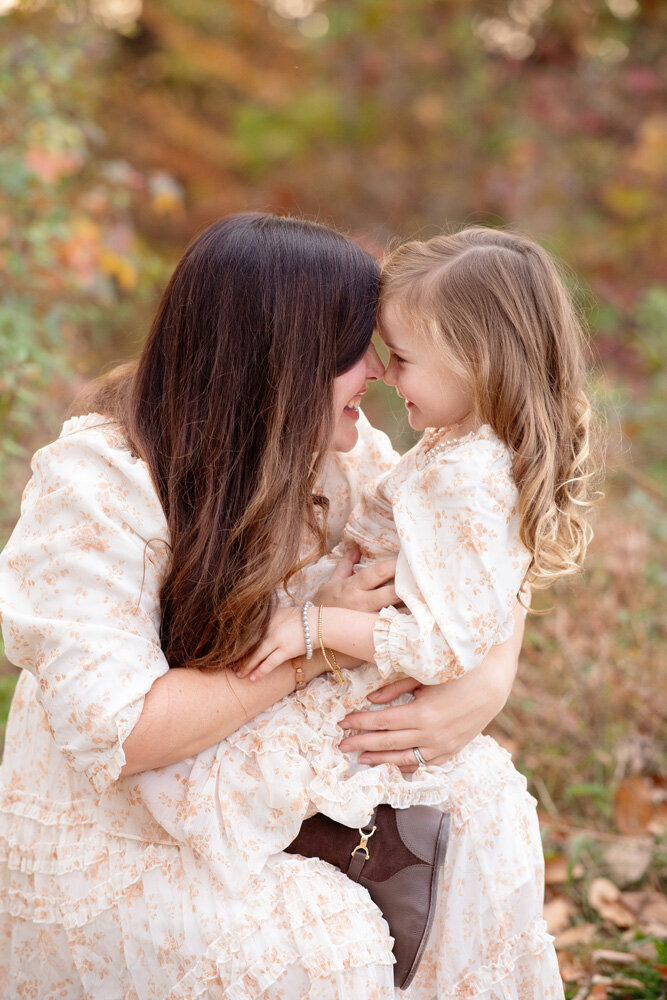 Family session of little girl and her mother wearing a dress