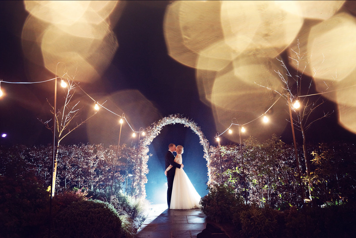 Night time fairy light portrait of a bride and groom at Owen House Barn Wedding Venue