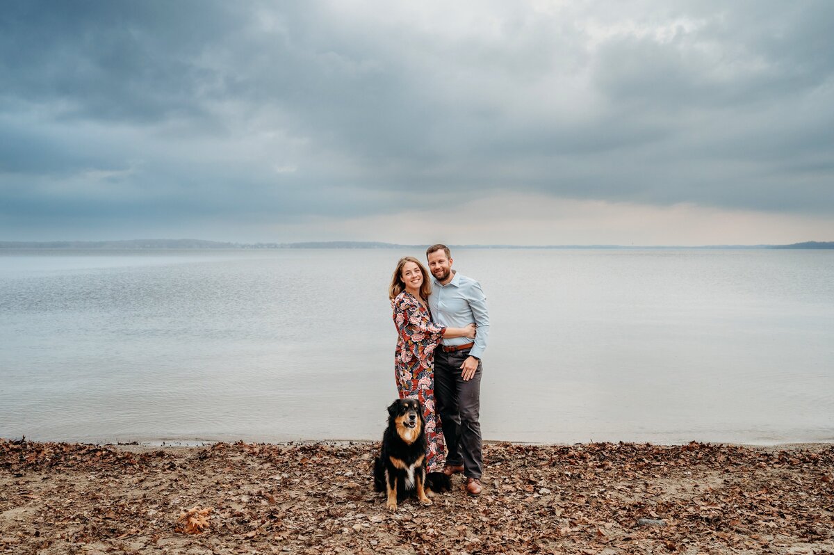 Couple and dog with lake behind McKennaPattersonPhotography