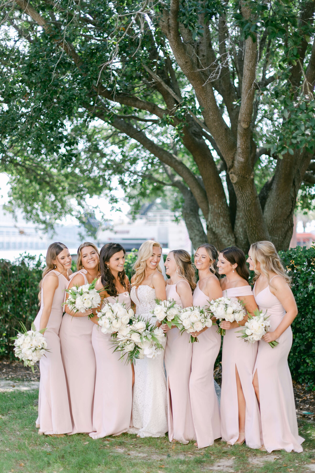 A bride huddles with her bridesmaids.