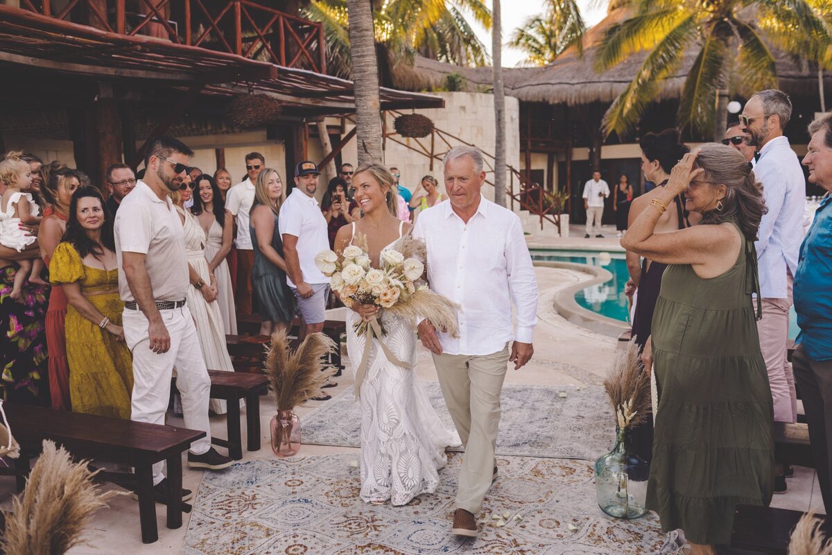 Bride walking down aisle with father at wedding in Riviera Maya